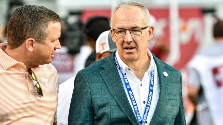 SEC commissioner on the sidelines at an Arkansas-Tennessee game